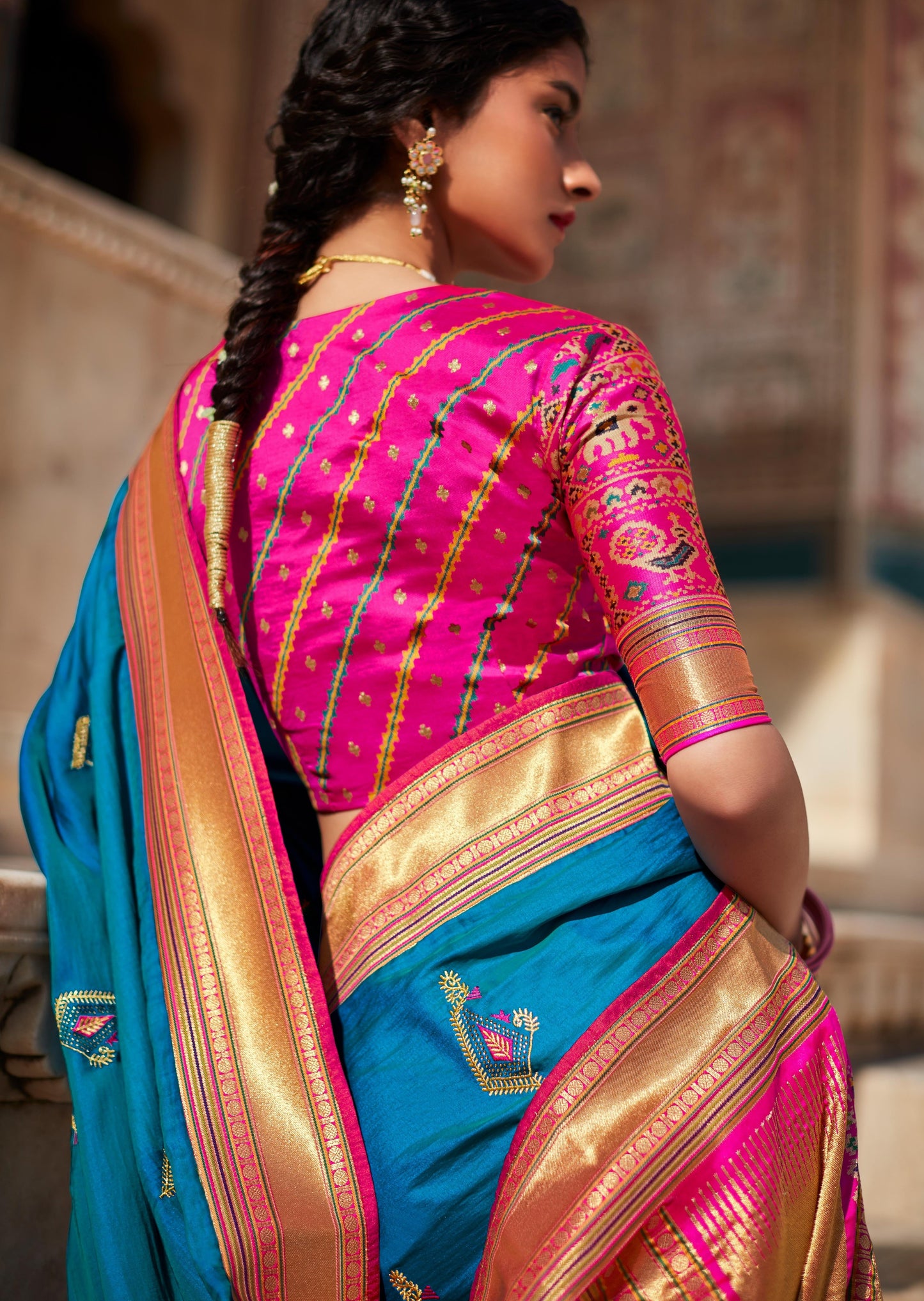 indian woman in braid hairstyle wearing Banarasi-Patola-Blue-Silk-Saree & pink blouse with Threadwork-Hand-Embroidery