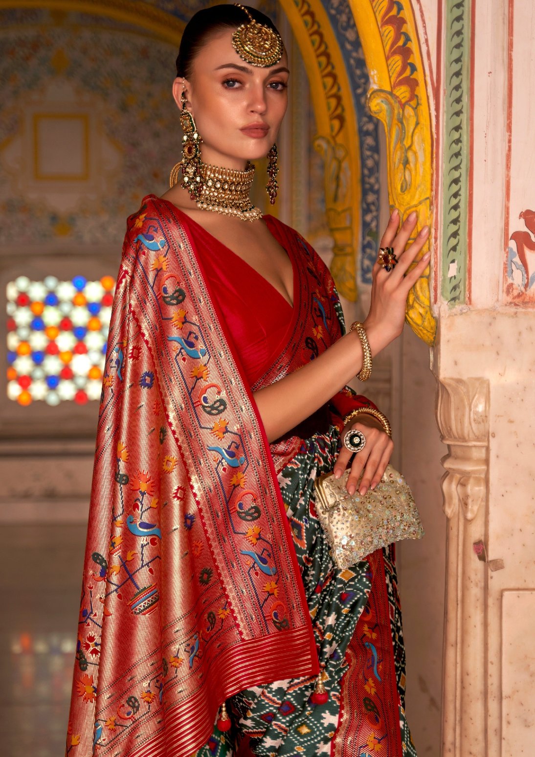 Handloom Patola sarees original design online in green red colour combination.