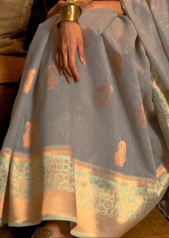 Pure linen saree online in grey and mint green color combination with broad gold zari weaving border and boota motifs.