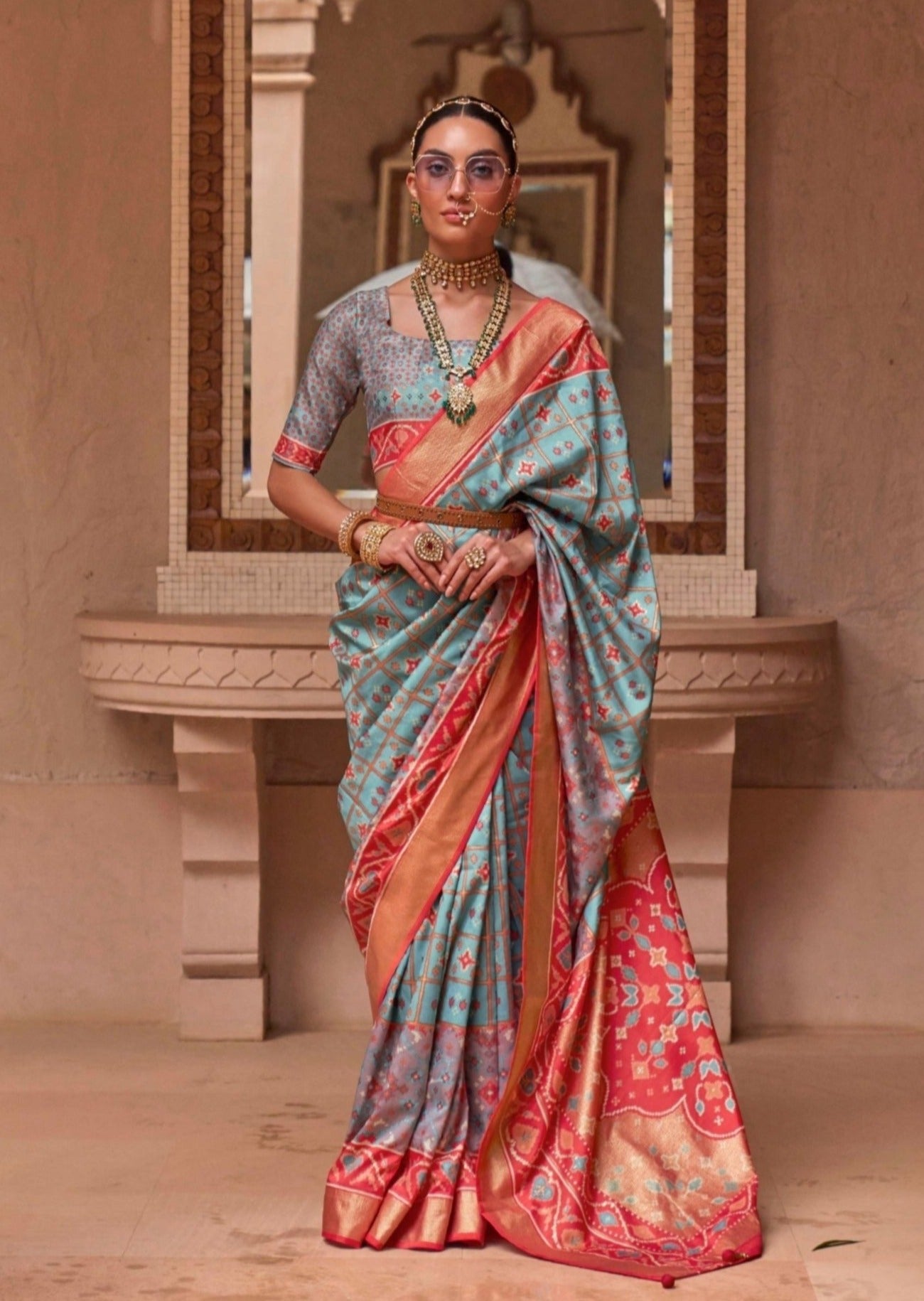 Woman standing in light blue double-ikkat-patola-saree