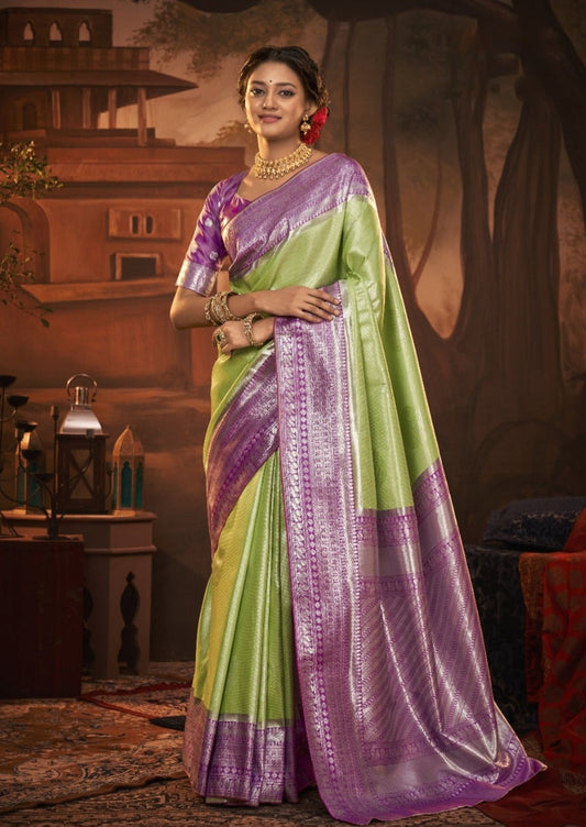 Woman's lime green pure kanjivaram silk saree with purple blouse.