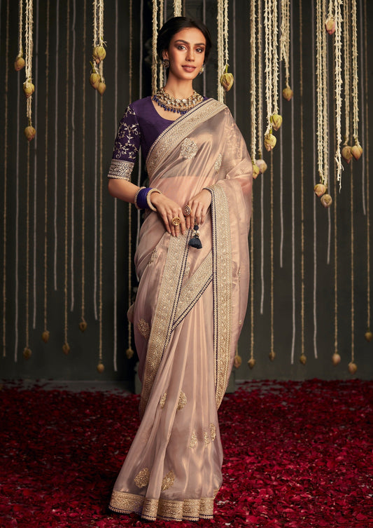 Organza tissue silk embroidered saree party wear pink color online shopping paired with purple blouse in contrast colour combination.