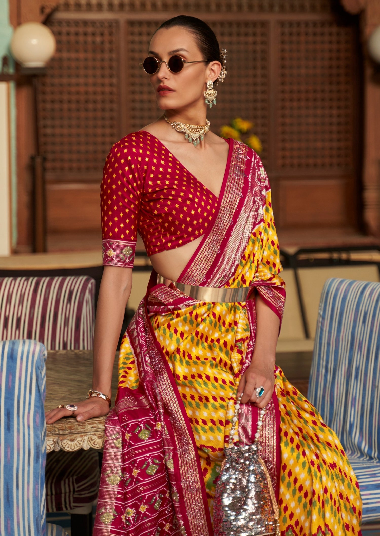 Woman wearing Patan Patola Silk Yellow Saree and red blouse