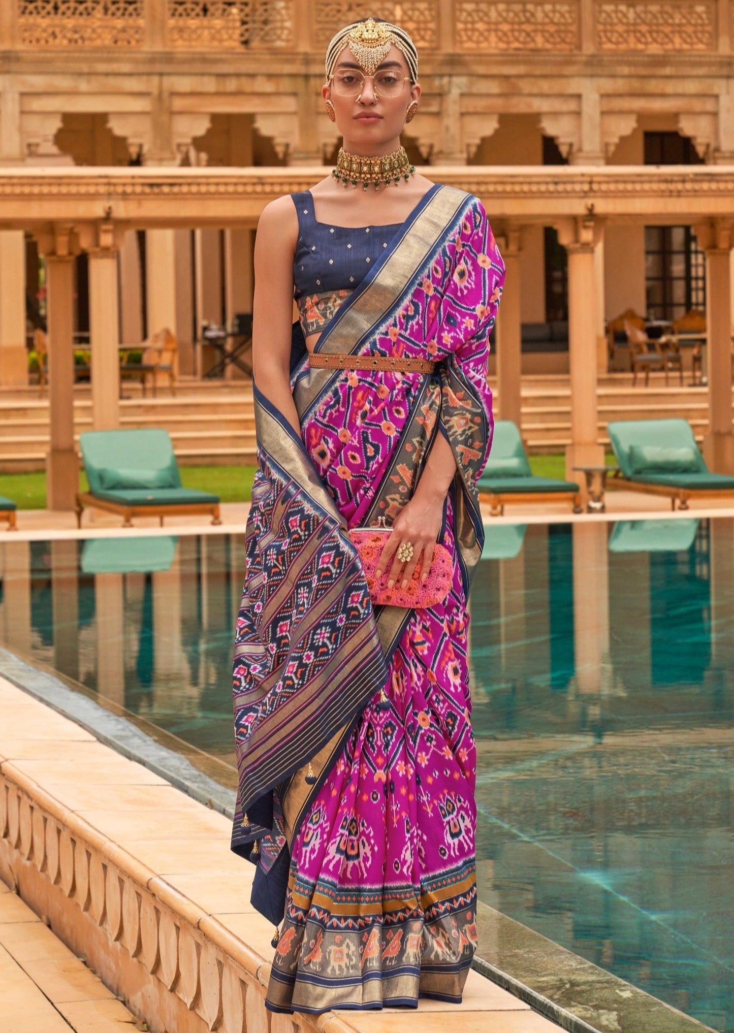 Woman in pink double ikkat saree wearing jewellery
