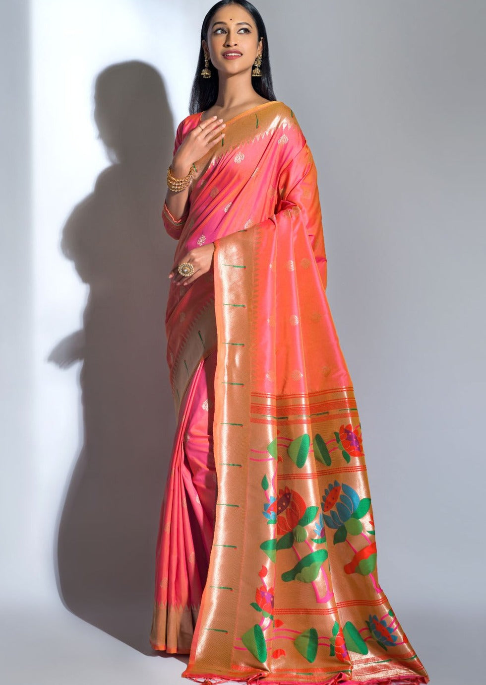 Woman wearing pure handloom paithani silk bridal orange saree