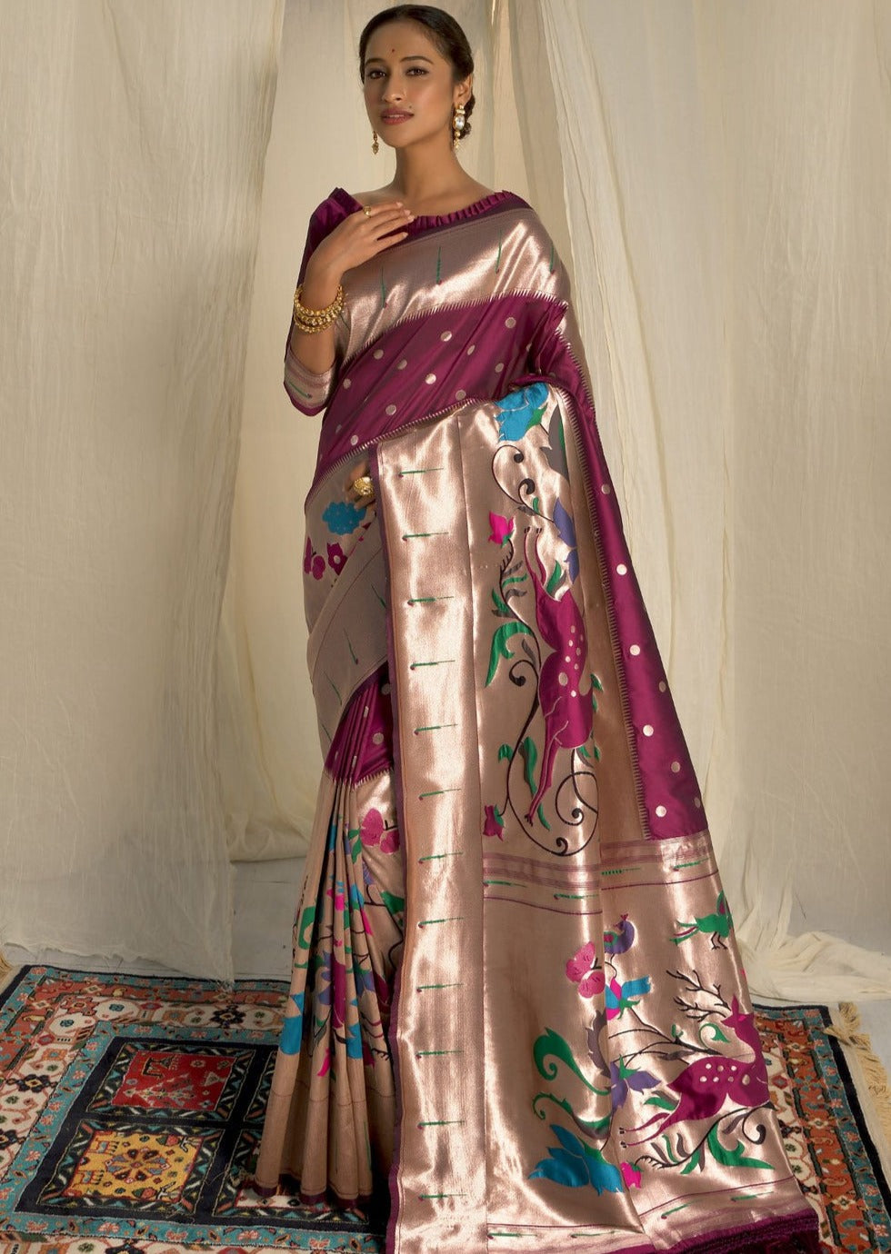 Woman wearing maroon color Paithani Saree