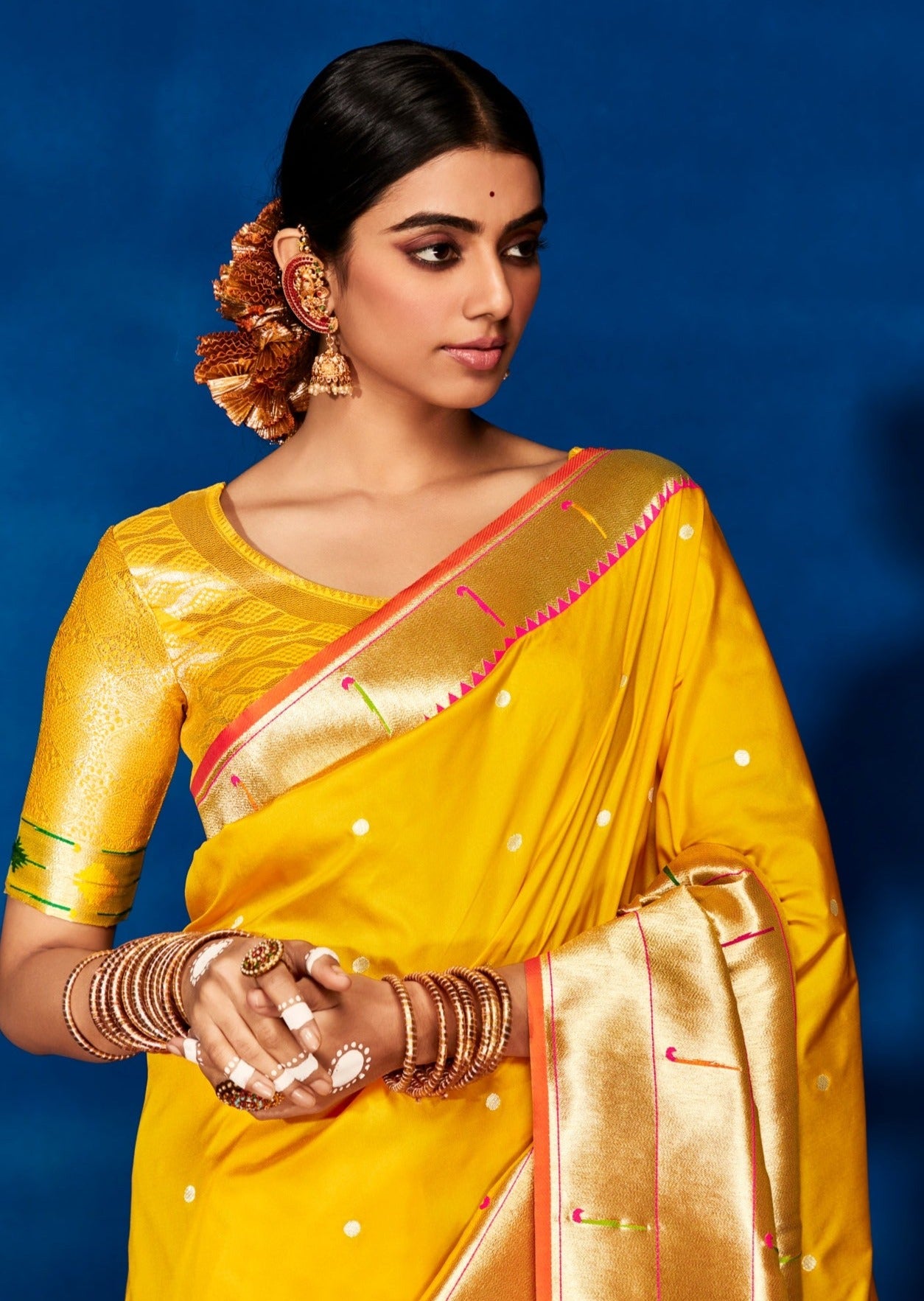 Woman wearing yellow Paithani saree