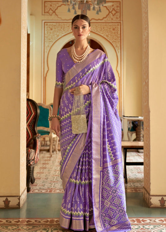 Purple patola saree online shopping design featuring traditional ikkat motifs and a matching blouse.