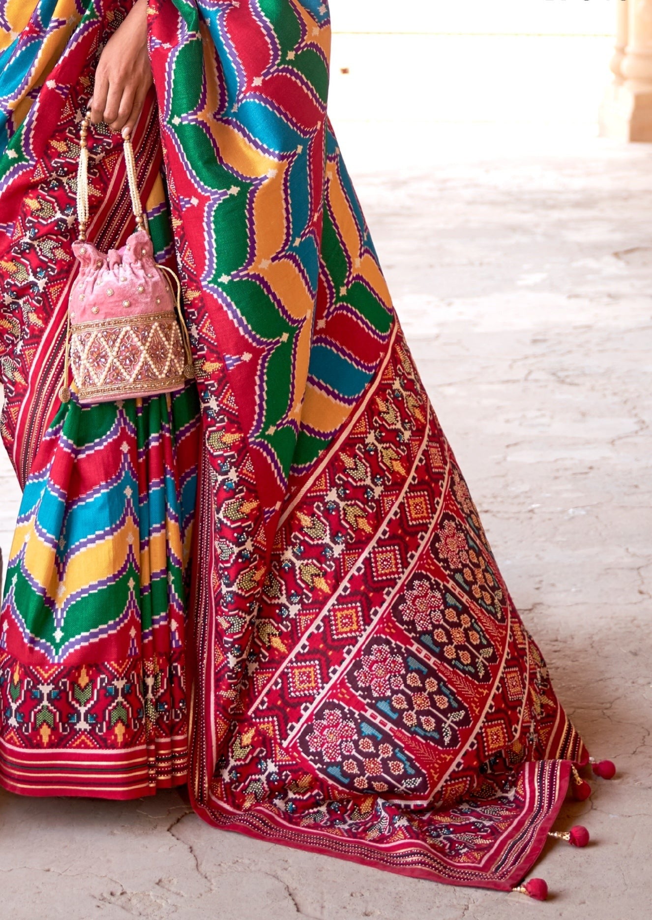 Vibrant red and multicolor patola saree featuring intricate traditional patterns and bold hues, showcasing a blend of rich colors and detailed craftsmanship, perfect for festive occasions.