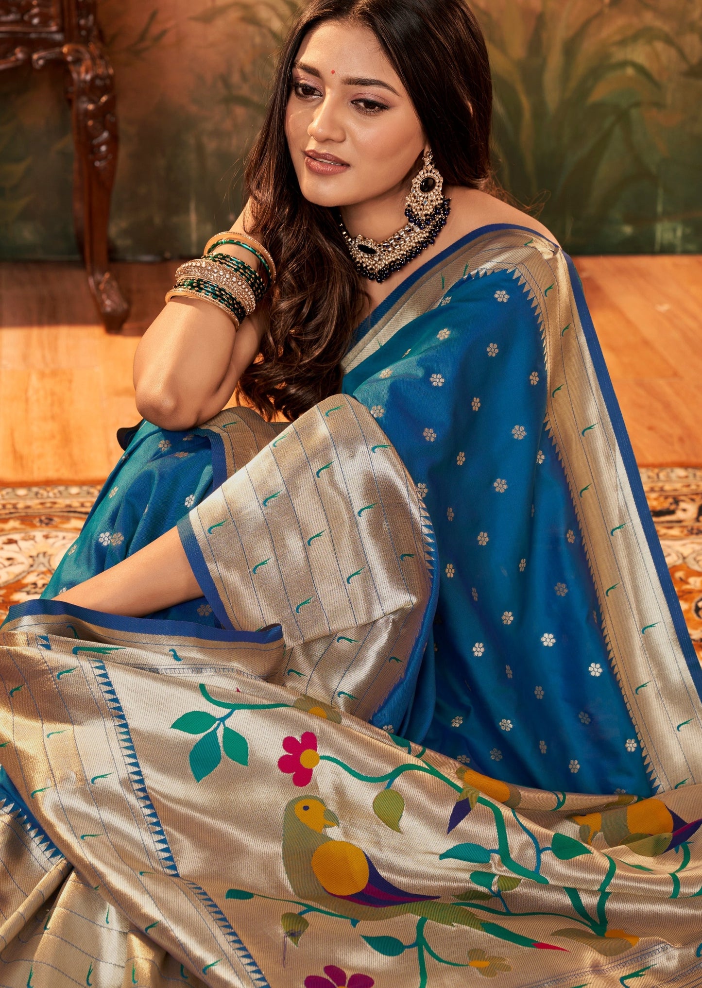 Woman wearing blue Paithani silk saree