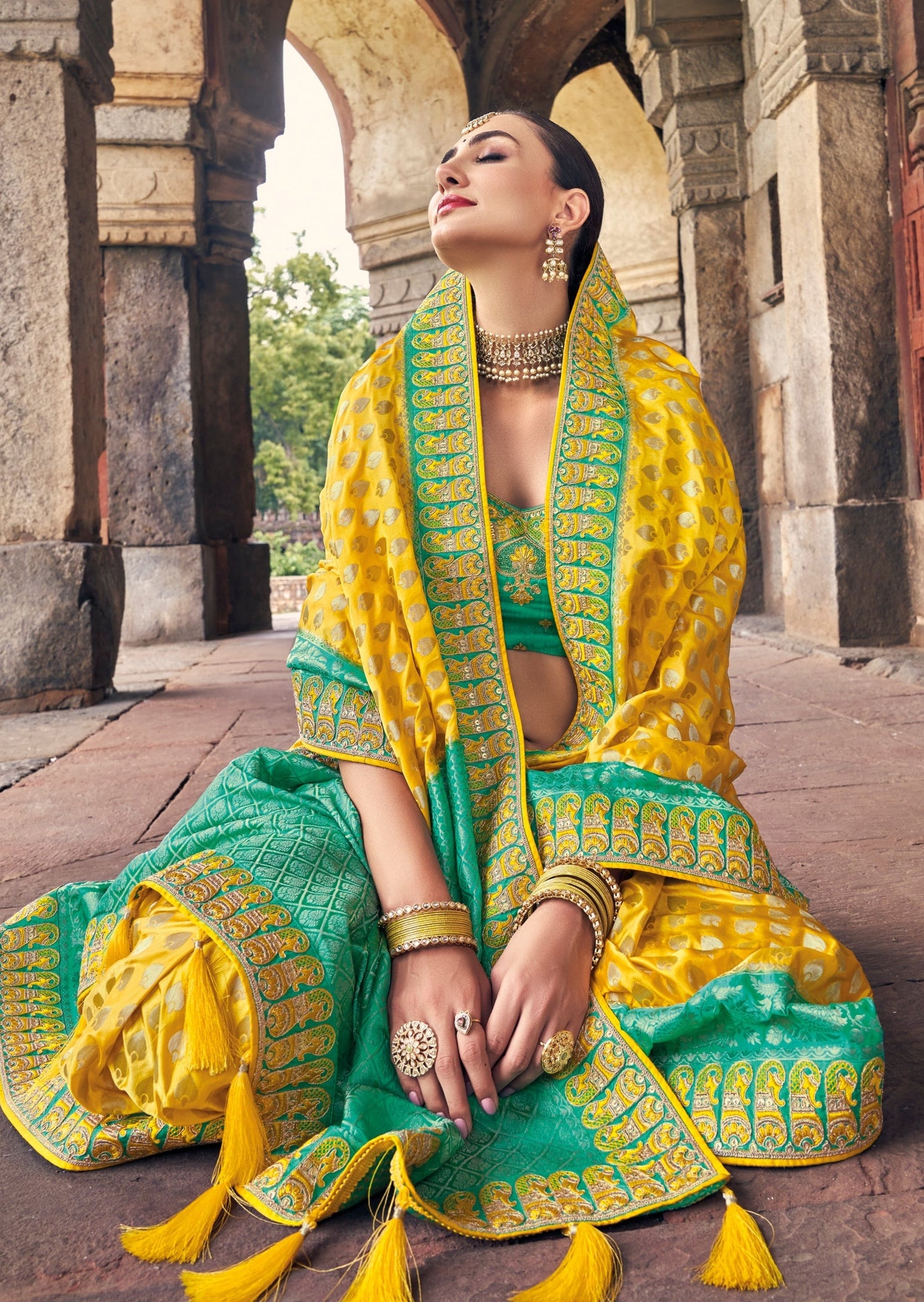 Designer yellow banarasi silk saree with Threadwork embroidery perfect for haldi ceremony, pheras and wedding rituals.