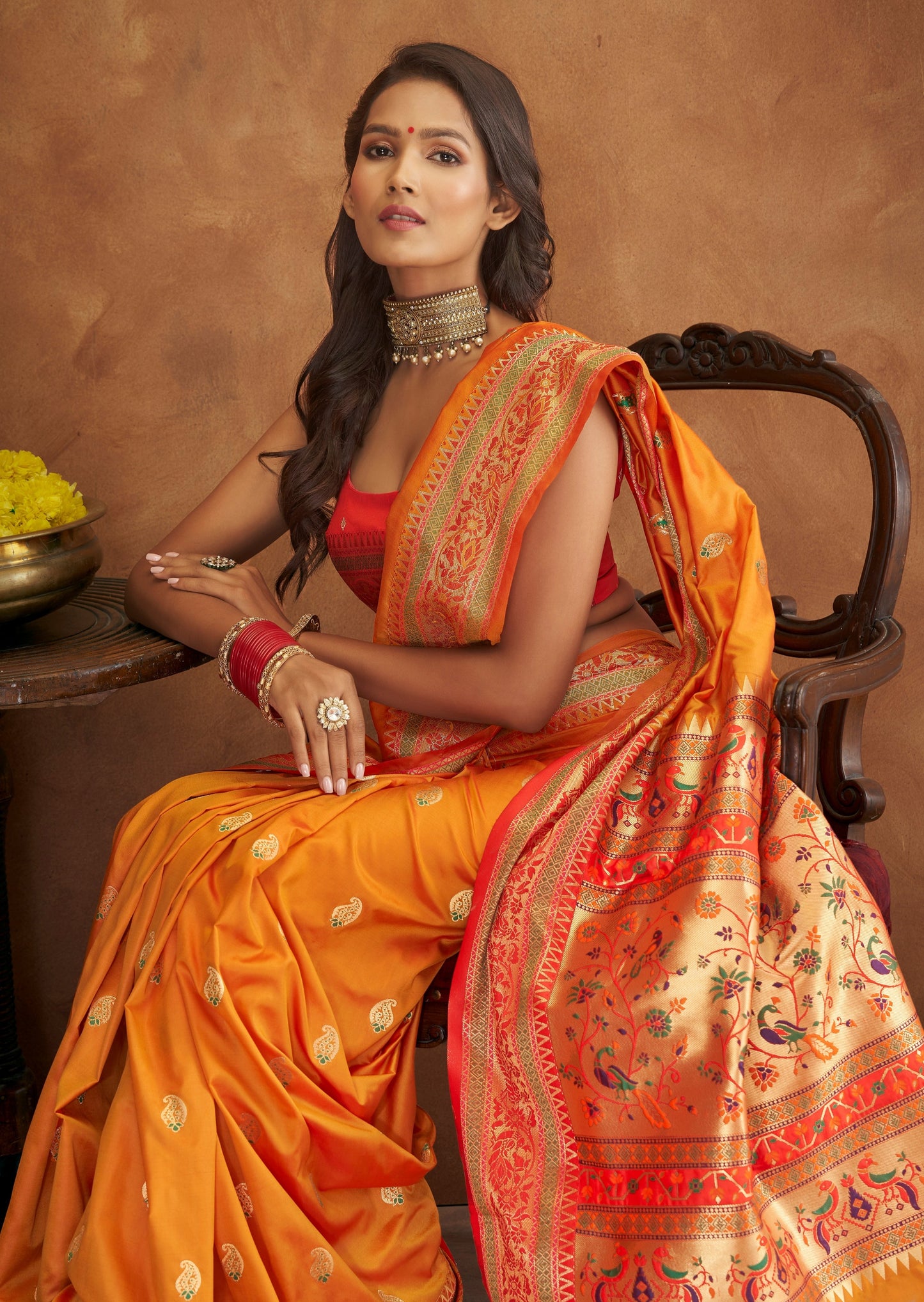 Yellow paithani silk saree online designs with contrast red blouse.